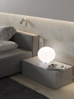 a modern living room with grey couch and white lamp