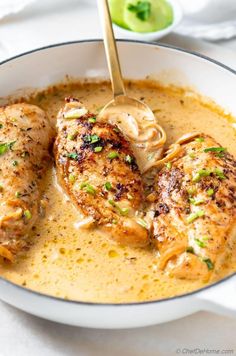 two pieces of chicken in a creamy sauce