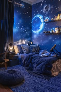 a bedroom decorated in blue with stars and planets on the wall