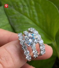 a person is holding a ring that has been set in the shape of a flower