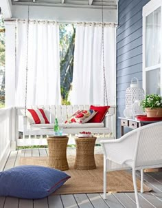 a porch with white furniture and blue walls