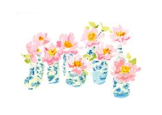 four blue and white vases with pink flowers in them