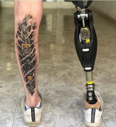 a person standing next to a parking meter with a tattoo on their leg and foot