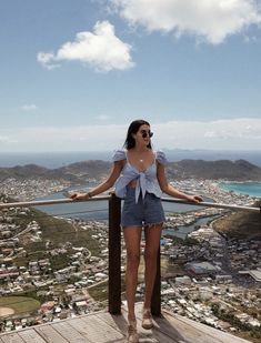 a woman standing on top of a wooden platform