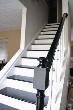 there is a black and white stair rail on the stairs