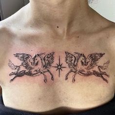 a woman's chest with two angels and a star tattoo on her left side