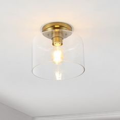 a light that is on the ceiling in a room with white walls and flooring