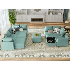 a living room filled with blue couches and pillows on top of a white rug