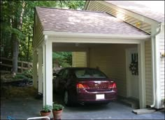 a car is parked in the garage with its door open