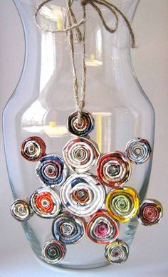 a glass vase filled with colorful spirals on top of a table