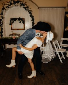 a bride and groom kissing on the dance floor