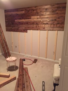 the room is being remodeled with wood accent wall