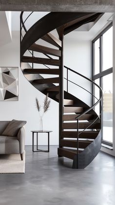 a living room with a couch and a spiral staircase in the center, next to a large window