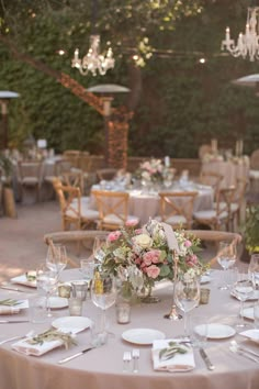 the table is set with flowers and place settings