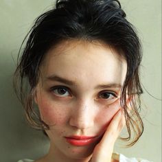 a young woman with freckled hair posing for the camera