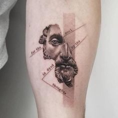 a man's leg with a tattoo on it that has an image of two men