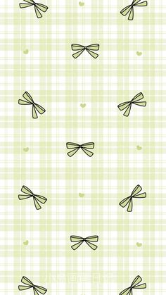 a green and white checkered wallpaper with bows