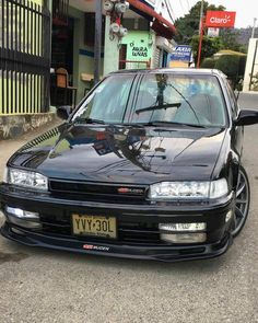 a black car parked in front of a building