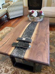 a wooden table with remote controls on it