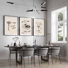 a dining room table with four chairs and three pictures on the wall above it,