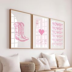 three pink and white pictures hang on the wall above a couch in a living room