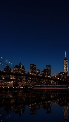 the city skyline is lit up at night