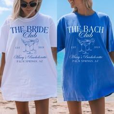 two women wearing matching shirts on the beach