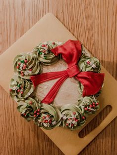 a christmas wreath cake on a cutting board