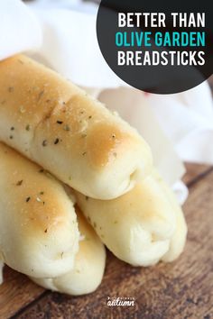 some bread rolls are stacked on top of each other with the words, better than olive garden breadsticks