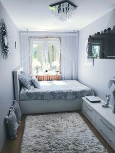 a bed room with a neatly made bed and a teddy bear