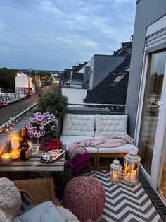 a balcony with candles and flowers on it