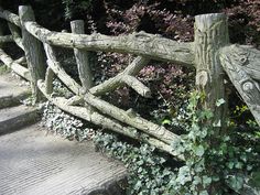 an old wooden fence with vines growing over it