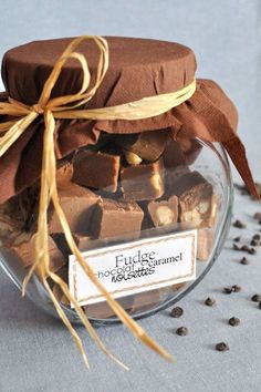 a glass jar filled with chocolate pieces on top of a table