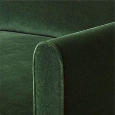 a close up view of the back end of a green couch