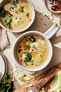 three bowls filled with soup on top of a table