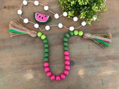 a watermelon necklace with tassels and beads