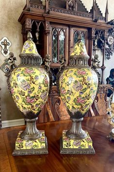 two vases sitting on top of a wooden table