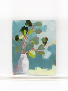 a painting of a white vase with green leaves in it on a wall above a shelf