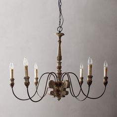 a chandelier with five candles hanging from it