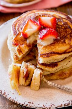 a stack of pancakes with strawberries on top