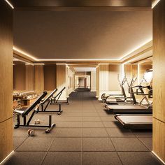 an empty gym with rows of treadmills and exercise equipment on the floor in front of them