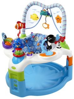 a blue and white baby's play gym with toys on the top of it