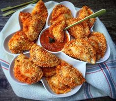 some fried food is on a plate with dipping sauce