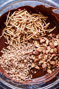 nuts and chocolate in a bowl on a table