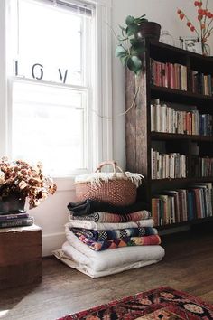 the room is full of books and pillows