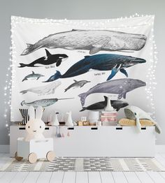 a wall hanging with whales on it and lights in the background, along with other items