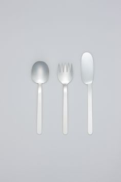 three spoons and two forks sitting next to each other