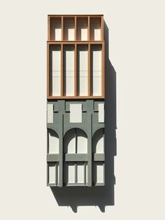 an architectural model of a building with arched windows and wooden slats on the side