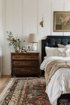 a bedroom with a bed, dresser and rug