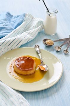 a plate that has some kind of dessert on it with spoons next to it